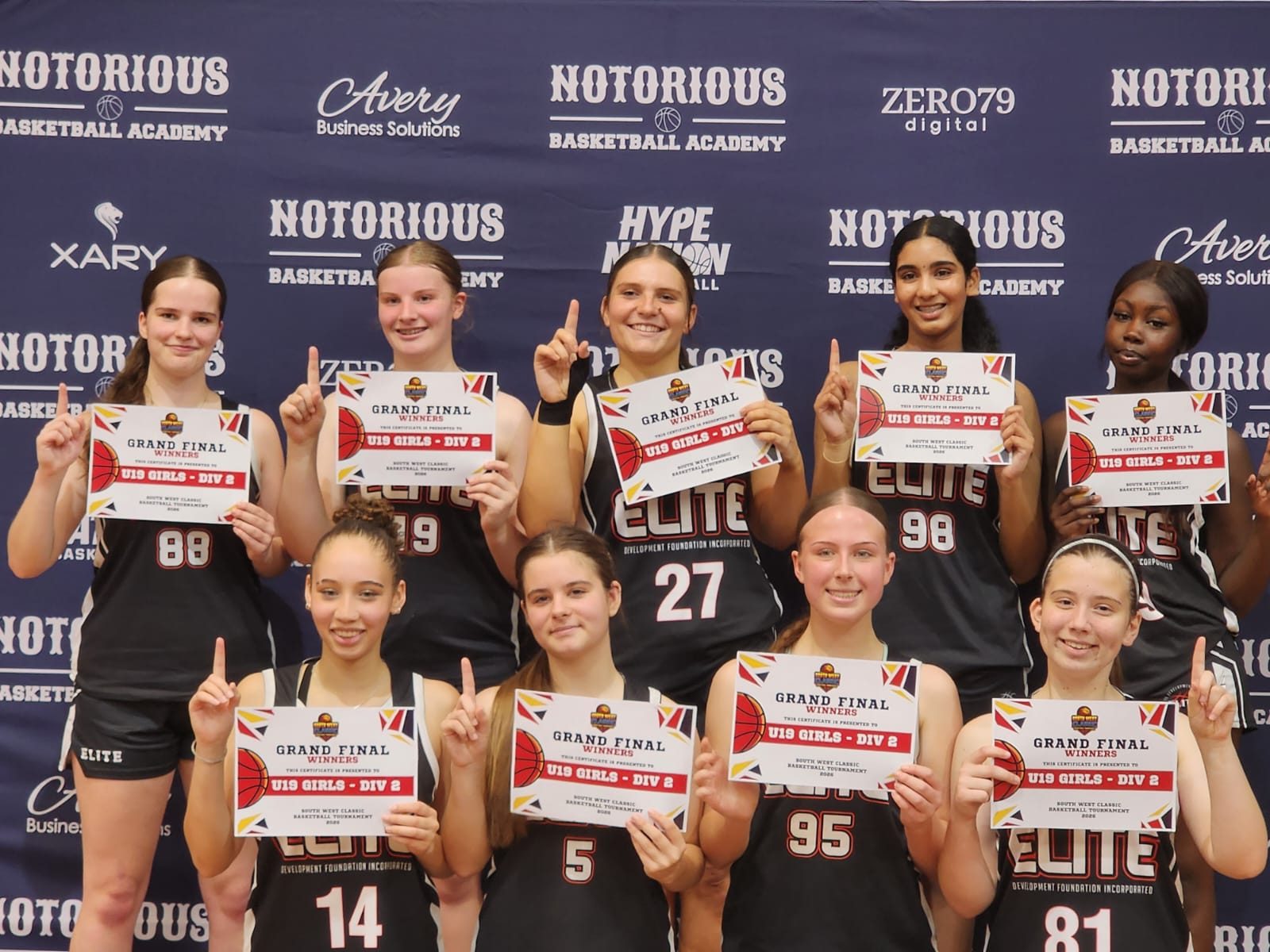 Elite players hold up Grand Final Winners certificates for U19 Girls Division 2 at the South West Classic 2026
