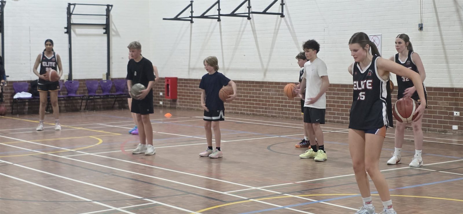 Elite players line up with balls at training